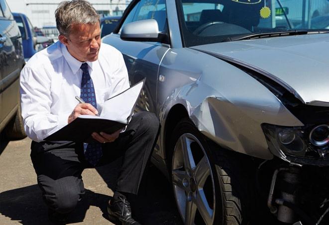 black car with insurance documents on dashboard